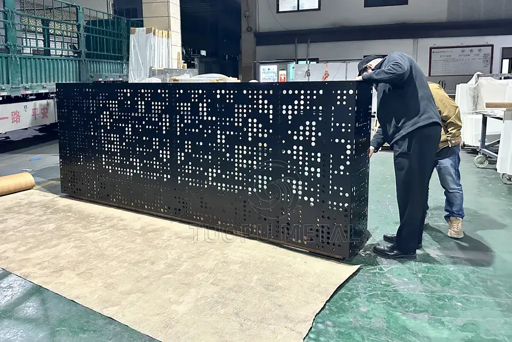 Showing customers checking the quality of laser cut aluminum fence in the factory