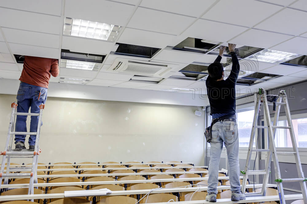 Workers are installing the t bar ceilings.