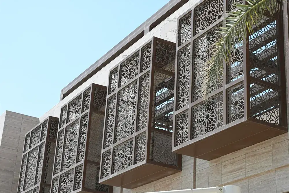 Decorative mashrabiya design aluminum panels installed on a modern building facade, providing an elegant blend of traditional Islamic architecture and contemporary aesthetics.