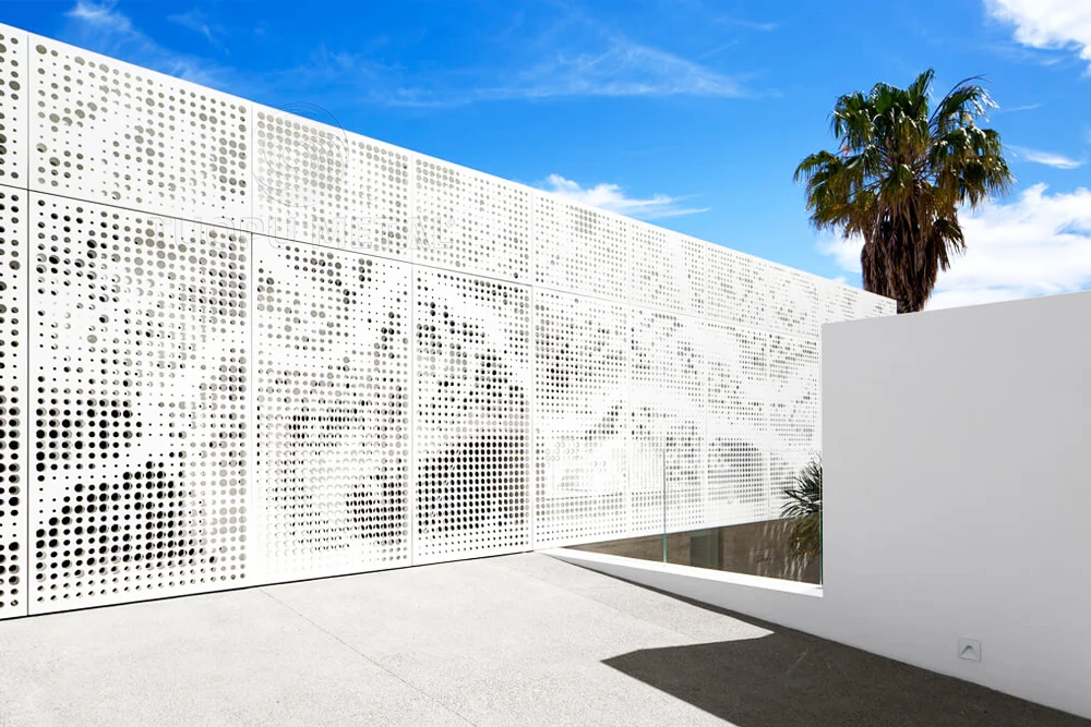 A decorative fence made of aluminum perforated panels.