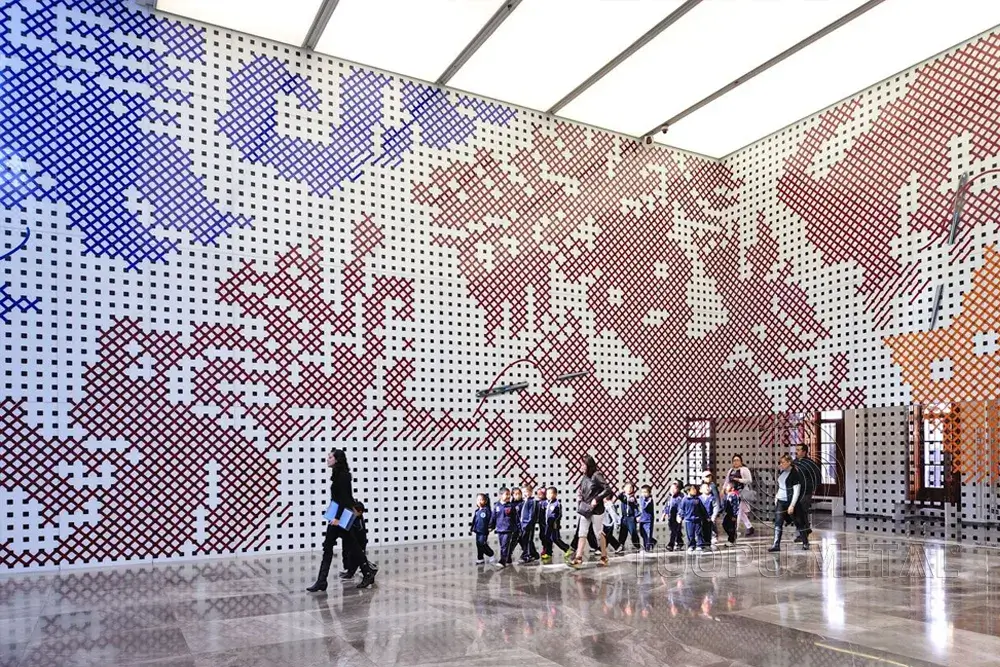 Public space featuring pixelated artwork on colorful aluminum panels.