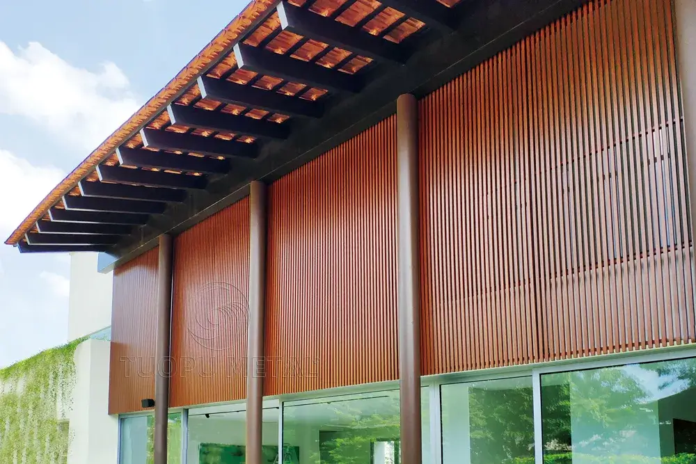 Close-up of a building's facade featuring wood grain aluminum panels.